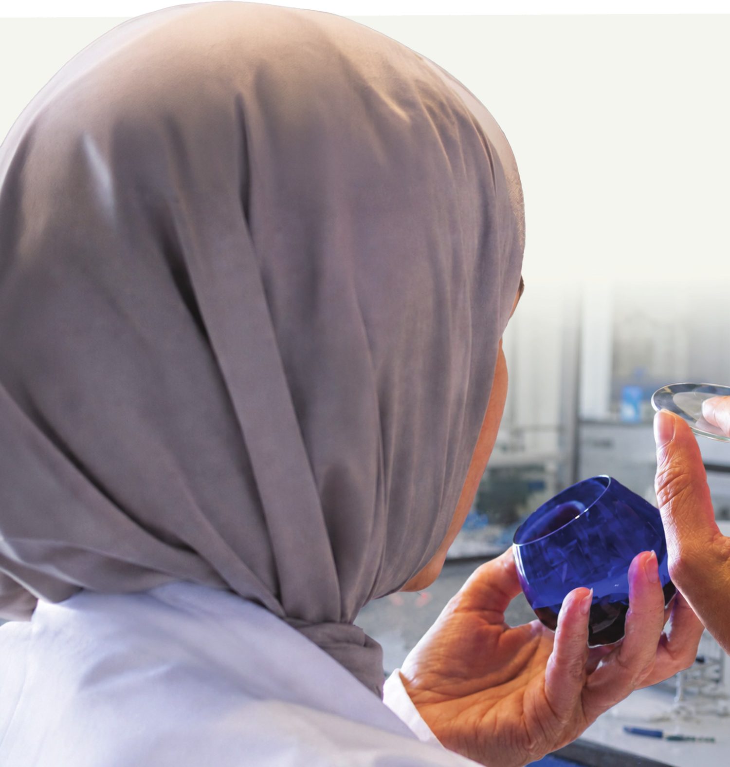 A scientist examining an olive oil sample in the lab